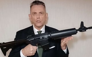 L-politikern poserar med vapen: 